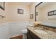 Charming powder room features granite vanity, framed mirror, and beadboard trim at 205 Pine Lake Dr, Cumming, GA 30040