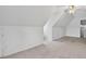 Finished attic space with a ceiling fan, carpeted floor, and storage at 65 Pecan Ln, Oxford, GA 30054
