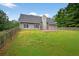 Large backyard with a wood fence and green grass at 65 Pecan Ln, Oxford, GA 30054