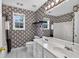 Bathroom with double vanity, patterned wallpaper, and tile flooring at 65 Pecan Ln, Oxford, GA 30054