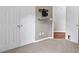 Bedroom featuring gray carpet, closet doors, and a tv wall mount at 65 Pecan Ln, Oxford, GA 30054