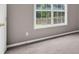 Bedroom with wall to wall carpet and a large window to the backyard at 65 Pecan Ln, Oxford, GA 30054