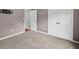 Bedroom featuring gray carpet, closet doors, and a tv wall mount at 65 Pecan Ln, Oxford, GA 30054