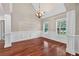 Elegant dining room featuring hardwood floors, wainscoting, and ample natural light at 65 Pecan Ln, Oxford, GA 30054