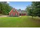 Charming brick home with a well-manicured lawn and inviting curb appeal in a desirable neighborhood at 65 Pecan Ln, Oxford, GA 30054