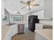 Bright kitchen with stainless steel appliances, white cabinets, and unique patterned tile floors at 65 Pecan Ln, Oxford, GA 30054