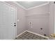 A laundry room with patterned tile floors, a white door, and a wire rack shelf at 65 Pecan Ln, Oxford, GA 30054