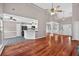 Open concept living area featuring hardwood floors, high ceilings, and a seamless flow to the kitchen at 65 Pecan Ln, Oxford, GA 30054