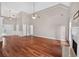 Expansive living room with hardwood floors, fireplace, and seamless flow to the kitchen and dining areas at 65 Pecan Ln, Oxford, GA 30054