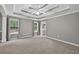 Large main bedroom with a tray ceiling and two windows providing great natural light at 65 Pecan Ln, Oxford, GA 30054