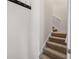 Carpeted staircase leading up to the second floor with a handrail at 65 Pecan Ln, Oxford, GA 30054