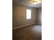 Neutral bedroom with neutral-toned walls, plush carpeting, and a window allowing natural light at 776 Crestside Ct, Austell, GA 30168
