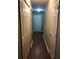 Hallway featuring vinyl floors and multiple doors including access to closets and other rooms of the home at 776 Crestside Ct, Austell, GA 30168