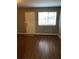 Bright living room featuring wood-look floors, a large window, and ample space for furniture arrangement at 776 Crestside Ct, Austell, GA 30168