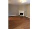 Cozy living room with hardwood floors and a traditional fireplace, perfect for relaxing and entertaining at 776 Crestside Ct, Austell, GA 30168