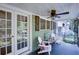 Inviting front porch featuring comfortable seating, a ceiling fan, and stylish decor at 958 Forrest Blvd, Decatur, GA 30030
