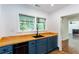 A kitchen with butcher block countertops, and shaker style cabinetry also has a view to living room at 958 Forrest Blvd, Decatur, GA 30030