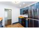 A well-lit kitchen includes blue cabinetry and a view into another room at 958 Forrest Blvd, Decatur, GA 30030