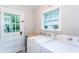 A laundry room with natural light from a window, plus access to outside at 958 Forrest Blvd, Decatur, GA 30030