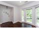 Bright living room features dark hardwood floors, large windows and white door with sidelights at 958 Forrest Blvd, Decatur, GA 30030
