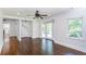 Open living room features dark hardwood floors, large windows and white door with sidelights at 958 Forrest Blvd, Decatur, GA 30030