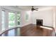 Spacious living room with fireplace, ceiling fan, and large bright windows with wooded view at 958 Forrest Blvd, Decatur, GA 30030