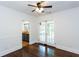 Corner of an open living room showing hardwood floors, half wall, doorways, and kitchen at 958 Forrest Blvd, Decatur, GA 30030