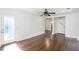 Open living room with ceiling fan, door to backyard and doorway to laundry room at 958 Forrest Blvd, Decatur, GA 30030