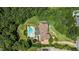 Aerial view of estate showing home, pool, hot tub, outdoor kitchen, and wooded surroundings at 170 Autry Trl, Johns Creek, GA 30022