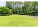 Expansive green backyard bordered by trees, offering plenty of space for recreation and relaxation at 170 Autry Trl, Johns Creek, GA 30022