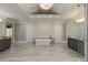 Airy bathroom with a vaulted ceiling, standalone tub, dual vanities, and decorative accent wall at 170 Autry Trl, Johns Creek, GA 30022