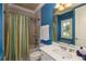 Updated bathroom featuring blue accent wall, bath/shower combo, and stylish decor at 170 Autry Trl, Johns Creek, GA 30022