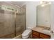 Bathroom showcases large glass shower, neutral tile and updated fixtures at 170 Autry Trl, Johns Creek, GA 30022