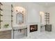 Luxurious bathroom with dual sinks, marble countertops, fireplace, and glass shelving at 170 Autry Trl, Johns Creek, GA 30022