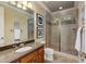 Bathroom showcases large glass shower, neutral tile and updated fixtures at 170 Autry Trl, Johns Creek, GA 30022