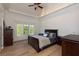 Bedroom with hardwood floors, ceiling fan, tray ceiling, and view of the outdoors at 170 Autry Trl, Johns Creek, GA 30022