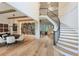 Grand foyer with hardwood floors, elegant staircase, and modern lighting at 170 Autry Trl, Johns Creek, GA 30022