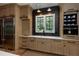 Well-lit kitchen featuring custom wood cabinetry, stainless-steel appliances, and a large window at 170 Autry Trl, Johns Creek, GA 30022