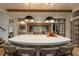 Bright kitchen island with stone countertops, modern seating, stainless appliances, and wine storage at 170 Autry Trl, Johns Creek, GA 30022