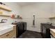 Functional laundry room with modern appliances, floating shelves, and a sink at 170 Autry Trl, Johns Creek, GA 30022