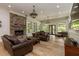 Expansive living room with stone fireplace, hardwood floors, and lots of natural light at 170 Autry Trl, Johns Creek, GA 30022