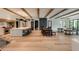 Bright, open-concept living and kitchen area featuring hardwood floors and exposed beams at 170 Autry Trl, Johns Creek, GA 30022