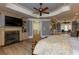 Large main bedroom with hardwood floors, fireplace, sitting area, and tray ceilings at 170 Autry Trl, Johns Creek, GA 30022