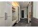 Stylish mudroom features built-in storage, a bench, and modern hexagonal tile flooring at 170 Autry Trl, Johns Creek, GA 30022