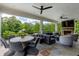 Inviting outdoor living space featuring a fireplace, comfortable seating, and a dining area at 170 Autry Trl, Johns Creek, GA 30022
