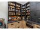 Well-organized walk-in pantry features custom shelves, cabinets, and counter space, offering ample storage at 170 Autry Trl, Johns Creek, GA 30022