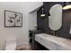 Modern powder room featuring a marble sink, unique mirror, and stylish decor at 170 Autry Trl, Johns Creek, GA 30022