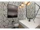 Chic powder room boasts eye-catching wallpaper, modern fixtures, and stylish design at 170 Autry Trl, Johns Creek, GA 30022