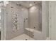 Modern shower with glass enclosure, gray tiles, multiple shower heads, and built-in seat at 170 Autry Trl, Johns Creek, GA 30022