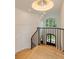 Elegant staircase with hardwood steps, black iron railing, and stylish chandelier at 170 Autry Trl, Johns Creek, GA 30022